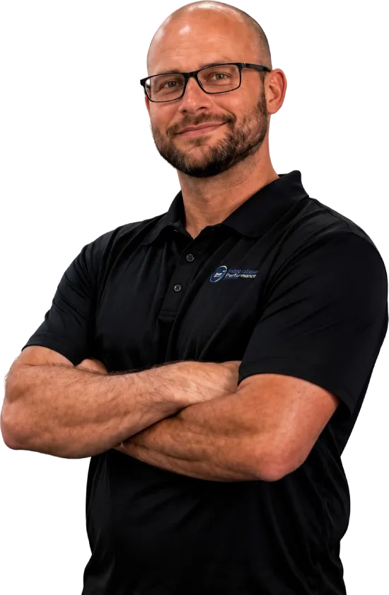 Smiling man with glasses and beard wearing a black polo shirt